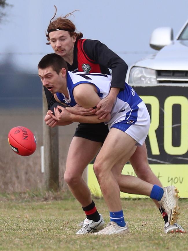 The ball spills free as Irrewarra-Beac’s Thomas Swayn tackles South Colac opponent Ben Cox.