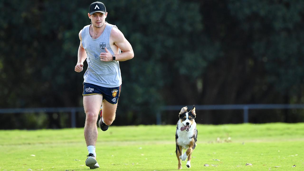 Lachie Neale running with his dog Harley. Photo: Darren England/AAP Image.