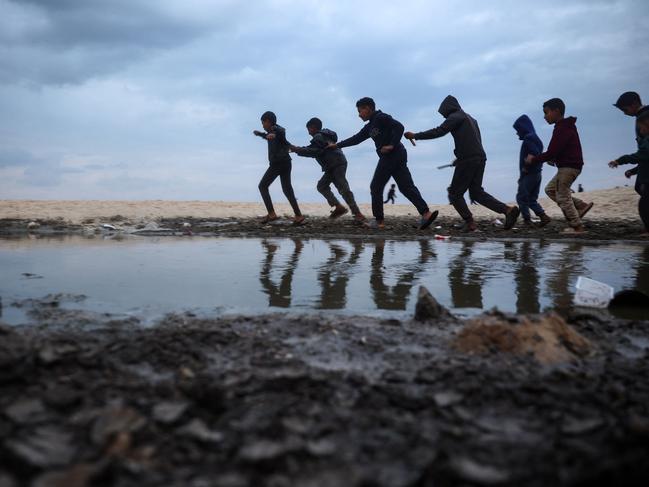 Palestinian children play along a beach in Deir el-Balah. Picture: AFP