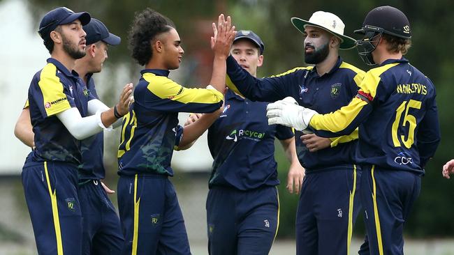 Naman Sharma celebrates a wicket with Plenty Valley teammates. Picture: Hamish Blair