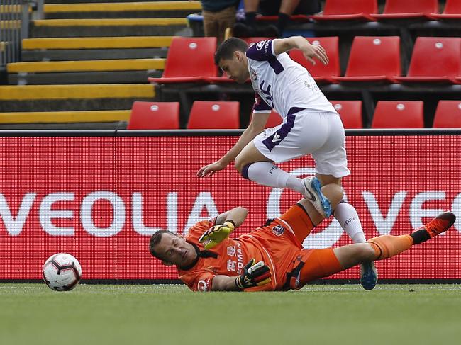 Joel Chianese of the Glory is fouled by Jets keeper Glen Moss during the Round 8 A-League match between the Newcastle Jets and the Perth Glory at the McDonald Jones Stadium in Newcastle, Sunday, December 16, 2018. (AAP Image/Darren Pateman) NO ARCHIVING, EDITORIAL USE ONLY