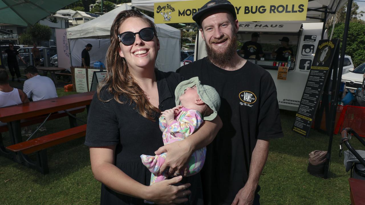 Katy Mills and Ryan Qualischefski with thier daughter Olive 9 weeks among the crowd at the 2025 Gold Coast Open surf comp at Burleigh Heads. Picture: Glenn Campbell