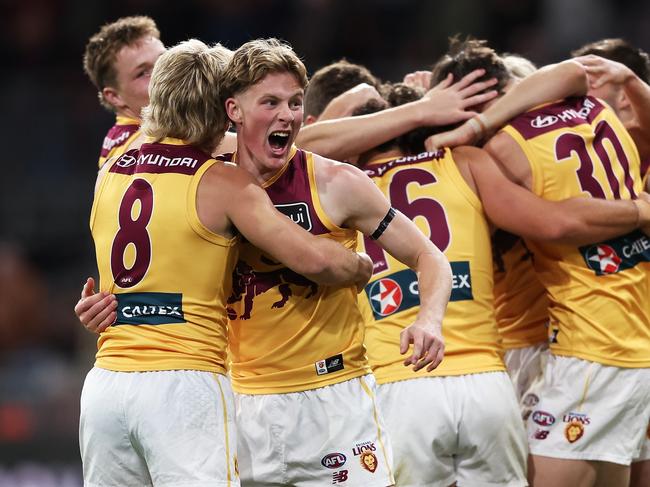 SYDNEY, AUSTRALIA - SEPTEMBER 14:  Logan Morris of the Lions celebrates victory with team mates at full time during the AFL First Semi Final match between GWS Giants and Brisbane Lions at ENGIE Stadium, on September 14, 2024, in Sydney, Australia. (Photo by Matt King/AFL Photos/via Getty Images)