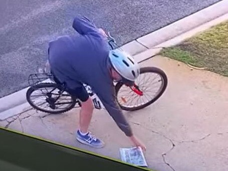 A cyclist allegedly steals newspaper from Mermaid Waters driveway. Picture: supplied