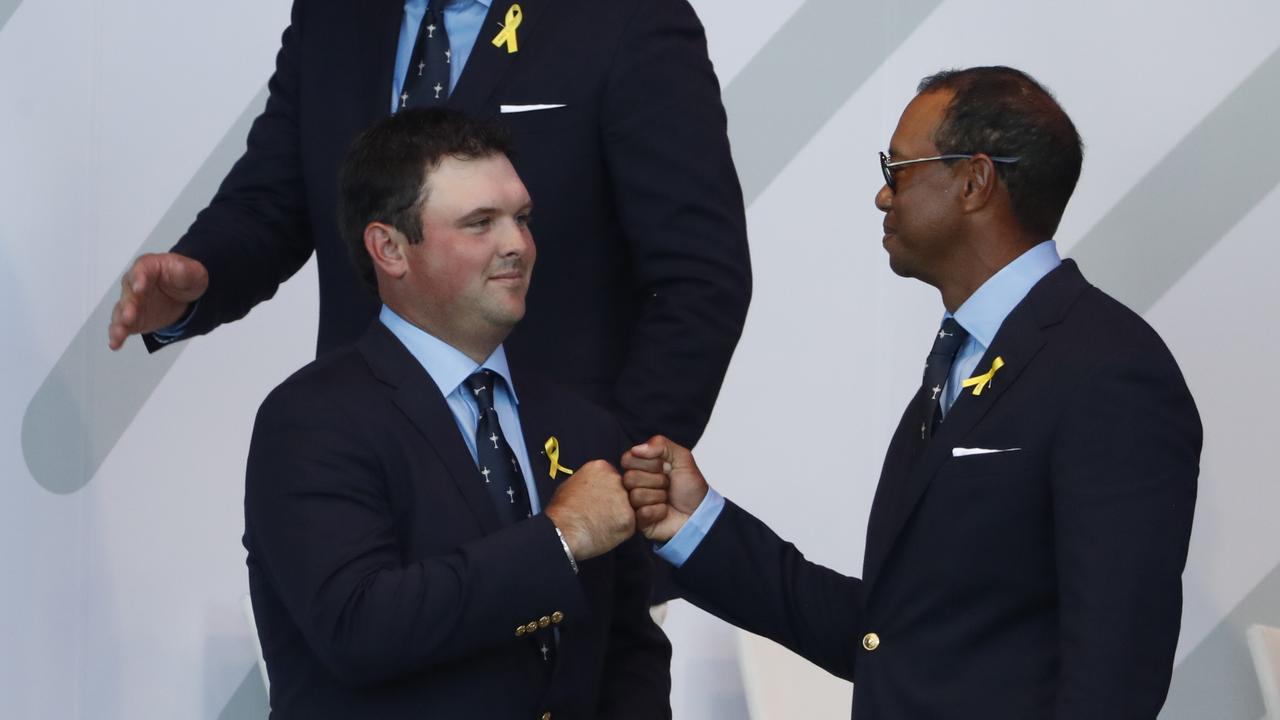 Patrick Reed and Tiger Woods, touch fists, after being paired to play together for the first day of the Ryder Cup.