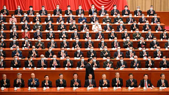 Xi Jinping, centre, walks past delegates in the Great Hall of the People on Sunday. Picture: AFP