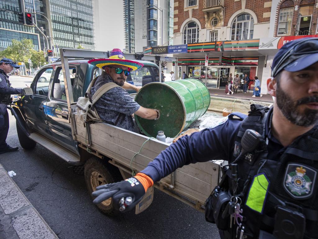 An activist from Extinction Rebellion with his arm in a barrel of cement. Picture: Glenn Hunt/AAP