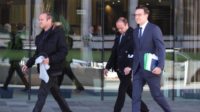 Joshua Tiffen, left, and Kenan Tiffen, centre, outside court with solicitor Tom Taylor.