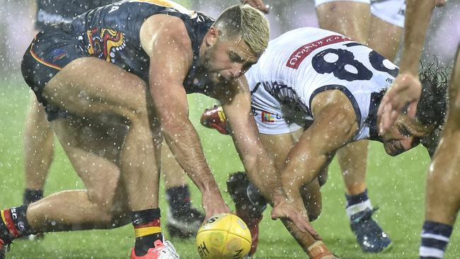 Rory Atkins of the Crows battles Docker Brady Grey in the rain at Adelaide Oval. Picture: David Mariuz (AAP)