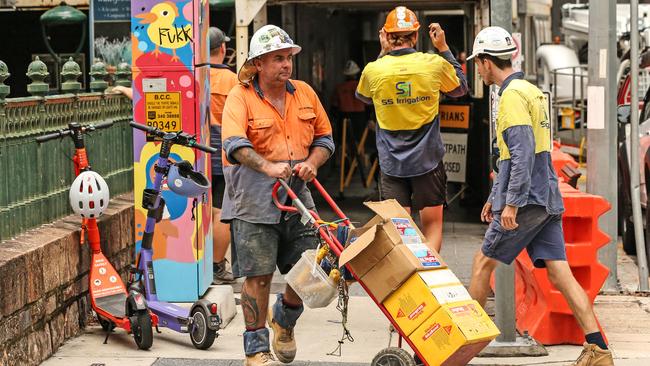 Workers leave the Probuild worksite on 443 Queen Street. Picture: Zak Simmonds