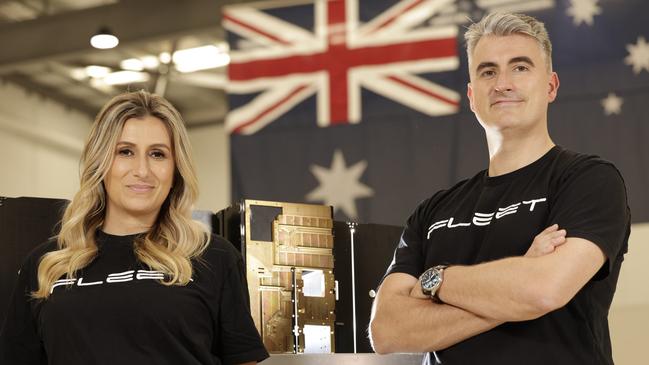 ADELAIDE, SOUTH AUSTRALIA - Advertiser Photos DECEMBER 9, 2024: Founders of Fleet Space CEO Flavia Tata Nardini and Chief Exploration Officer (CXO) Matthew Person with a satellite in their Beverley, SA premises. Picture Emma Brasier