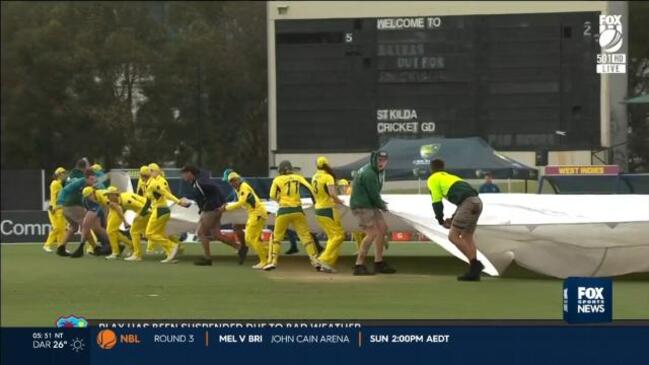 Aussie squad turn ground staff in storm