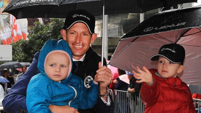 Jockey Hugh Bowman, who rides Twilight Payment, with his daughters Paige and Bambi during the parade. Picture: Getty Images