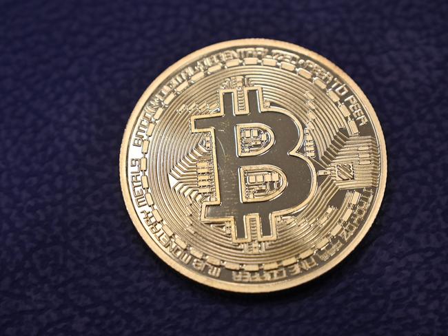 (FILES) In this file photo taken on December 17, 2020 shows shows a physical imitation of a Bitcoin at a crypto currency "Bitcoin Change" shop, near Grand Bazaar, in Istanbul. - Bitcoin soared above $50,000 for the first time on February 16, 2021, after surging by almost 75 percent this year as heavyweight companies lend their support to the world's most popular virtual currency. At around 1235 GMT, bitcoin hit an all-time high at $50,547.70, a 4.4-percent gain  since Monday. (Photo by Ozan KOSE / AFP)