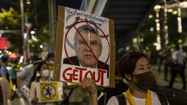 A protester holds a placard of International Olympic Committee President Thomas Bach during a demonstration against the forthcoming Tokyo Olympics.