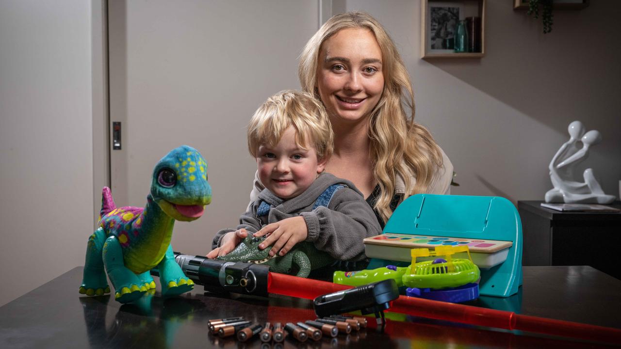 Emily Thiesz with her son Wilbur and some of his many toys that need batteries. Picture: Brad Fleet