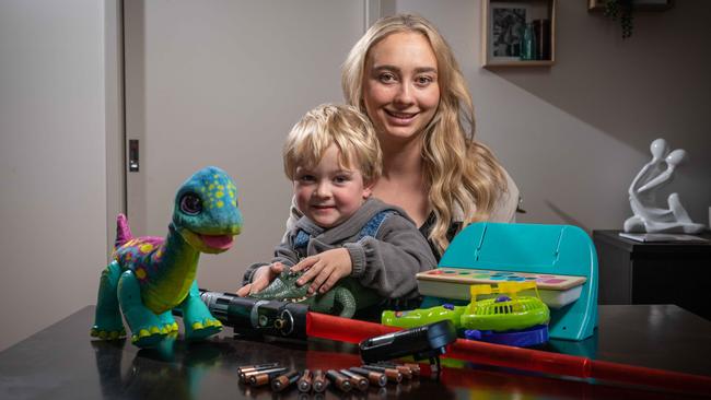 Emily Thiesz with her son Wilbur and some of his many toys that need batteries. Picture: Brad Fleet