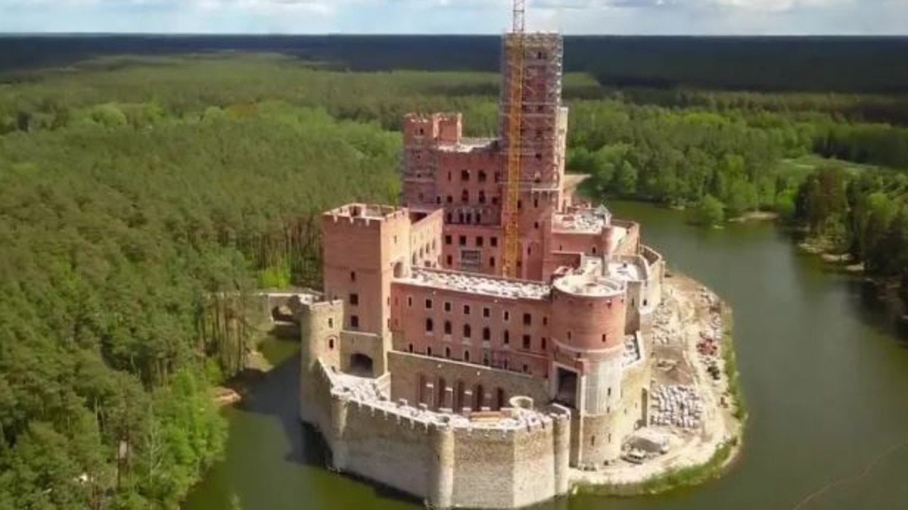 The bizarre castle was built on a man-made island on the lake. Picture: YouTube / Wojciech Bogacz