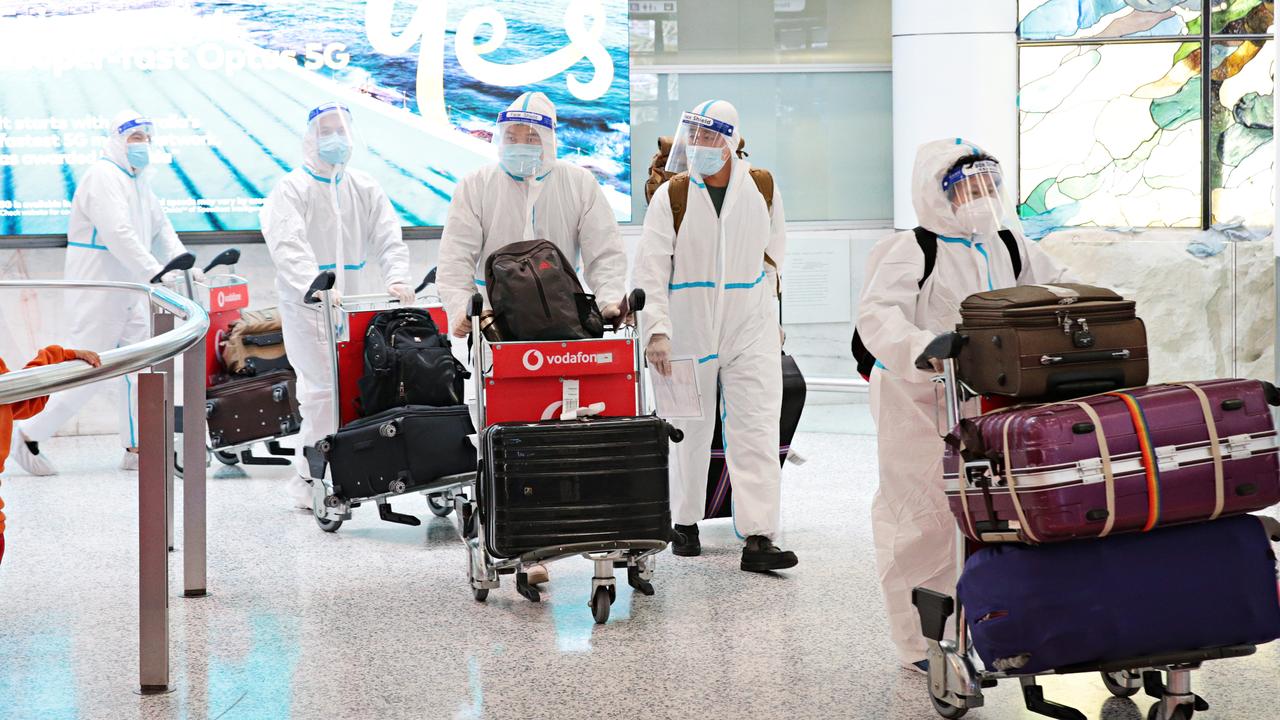 People in full PPE arriving at Sydney International Airport. Picture: Adam Yip