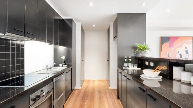 The granite-fitted kitchen is equipped with Miele appliances and a breakfast bar and servery.