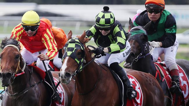 Jack Deripper, ridden and trained Chelsea Jokic (centre, green and black silks), beats Invincible Tammy, ridden by Marnu Potgieter, in Race 3 at Cannon Park, Woree. PICTURE: BRENDAN RADKE.