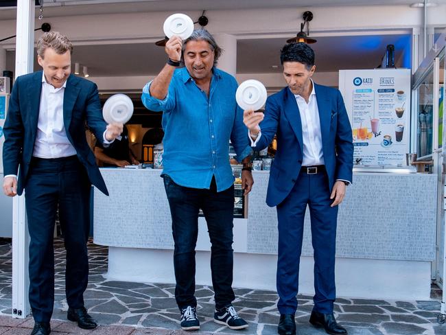 Left to right: Manly MP James Griffin, Kazzi Beach Greek owner Peter Papas and Minister Victor Dominello, smashing plates at the opening of the new restaurant in North Steyne. Picture: Supplied.