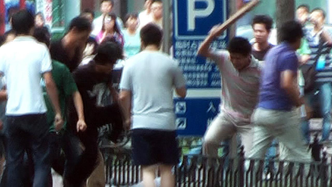 A mob of Han Chinese attacking a lone Uighur man in Urumqi in 2009. Picture: AFP