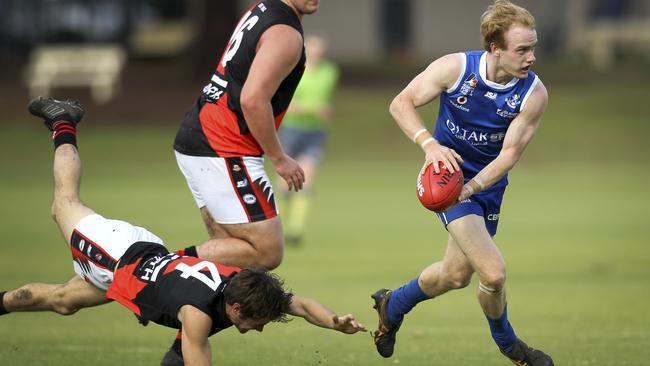 St Peter’s OC’s Nick McGill manages to escape a diving tackle from Tea Tree Gully Nick Thompson. The Wolves fell short in season 2019. Picture: AAP/Dean Martin