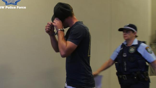 Caine Rootes being taken to Dubbo Police Station after his arrest. Picture: NSW Police