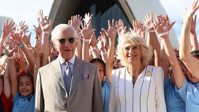 SYDNEY, AUSTRALIA - OCTOBER 22: King Charles III and Queen Camilla pose for a photo with students at the Sydney Opera House on October 22, 2024 in Sydney, Australia. The King's visit to Australia is his first as monarch, and the Commonwealth Heads of Government Meeting (CHOGM) in Samoa will be his first as head of the Commonwealth. (Photo by Chris Jackson/Getty Images)