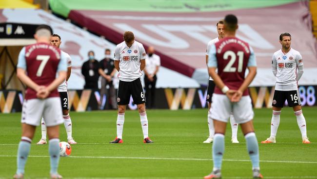 Players observe a minute’ silence before the English Premier League football match between Aston Villa and Sheffield United at Villa Park in Birmingham. Picture: AFP