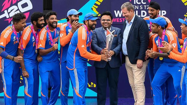 Secretary of the Board of Control for Cricket in India Jay Shah and India's captain Rohit Sharma accept the trophy. Picture: AFP