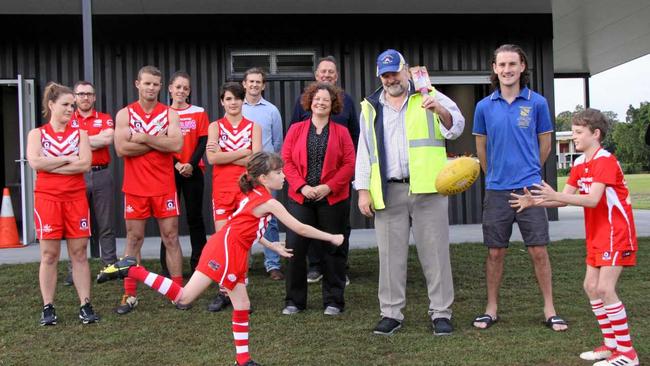 KICKING GOALS: Lismore's Deputy Mayor Elly Bird (centre) and Lismore Junior AFL Club players Neva Smith, 9, and Sydney-Jack Baker, 9 with Lismore City Council staff, and local AFL and cricket players, friends and supporters celebrate the opening of the new amenities block at Mortimer Oval. Picture: Alison Paterson