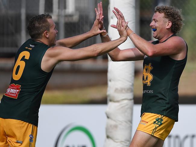 Jackson Calder, right, celebrates with Shaun Edwards after kicking his tenth goal against Tiwi in round 3 of the NTFL. Picture: Felicity Elliott / AFLNT Media