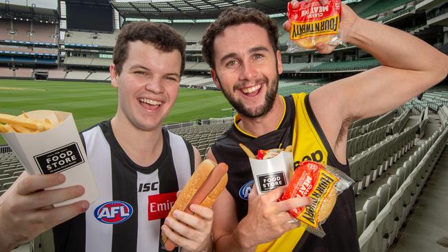 AFL fans Tim Hill and Luke Draffen with their favourite footy food at the MCG. Picture: Jay Town