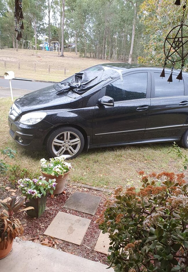 Posting about the bizarre sight, Michelle Rampton revealed she walked out her front door that morning to find the black hatchback casually parked across her grass. Picture: Facebook