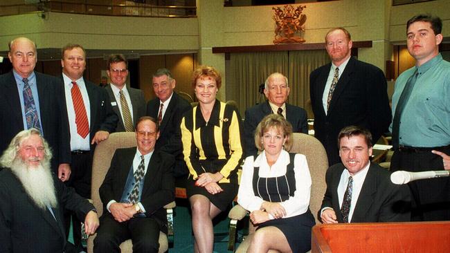 Pauline Hanson with One Nation MPs, (L-R) Ken Turner (kneeling), Jack Paff, Jeff Knuth, David Dalgleish, Charles (Charlie) Rappolt (seated), Harry Black, John Kingston, Dorothy Pratt (seated), Bill Feldman, Peter Prenzler (seated) and Shaun Nelson at Queensland State Parliament House in Brisbane in 1998.