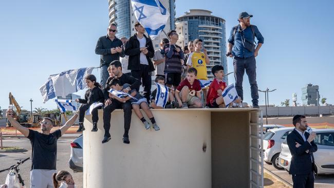 Israelis wait in a carpark for the arrival of a helicopter carrying the four released hostages outside Belinson-Schneider Hospital in Tel Aviv on January 25. Picture: Getty Images