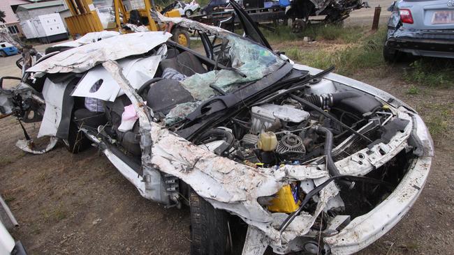 The remains of the white Holden Commodore sedan which crashed on the Bruce Highway south of The Caves killing four people in January 2011. Picture: The Morning Bulletin