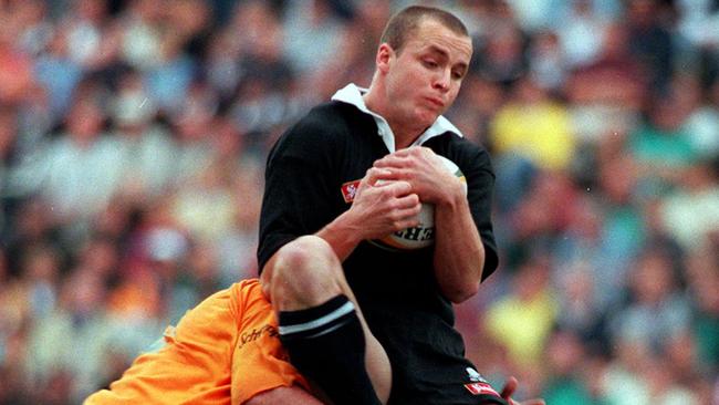 Wallabies' Daniel Manu tackles All Black Christian Cullen in the air during at Ballymore, 1996.