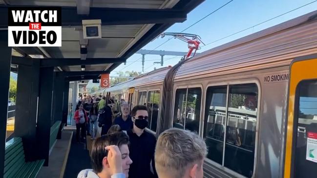 Commuters board a Brisbane train on Tuesday