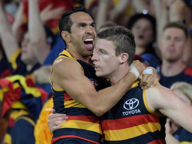 Eddie Betts of the Crows jumps on Josh Jenkins of the Crows as he celebrates a goal during the Adelaide Crows and Geelong Cats Men's AFL First Preliminary Final at the Adelaide Oval in Adelaide, Friday, September 22, 2017. (AAP Image/Tracey Nearmy) NO ARCHIVING, EDITORIAL USE ONLY