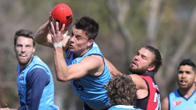 Sturt's Jack Stephens takes a strong mark in front of West's Mason Middleton. Picture: AAP/Dean Martin).