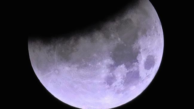 The shadow of the earth passes through the moon during a total lunar eclipse over Los Angeles. Picture: AP