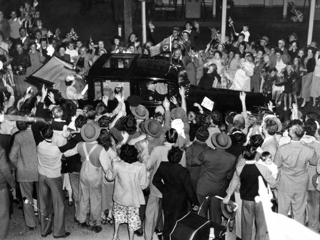 Crowds of people rush the Queen’s car on the road at Gepps Cross as she made her way from Parafield Airport to the city in 1954