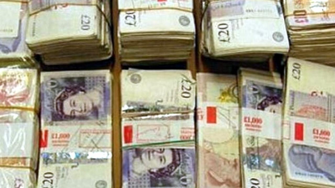 Piles of cash swiped in the scam were recovered by police. Picture: Central News