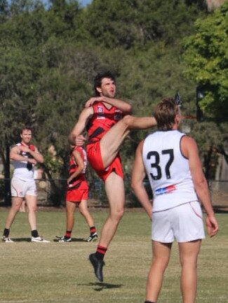 Burleigh Bombers player Josh Hall kicks for goal. Picture credit: Bethany Ryan.