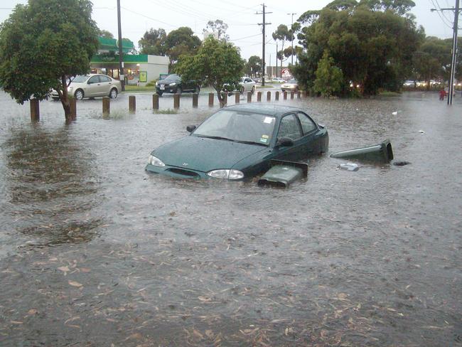 A car floating in floodwaters in Hoppers Crossing in 2012. Picture: HWT Library.