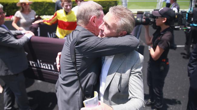 Trainer Mark Newnham (right) is hugged by an owner after Quackerjack’s win. Picture: Getty Images