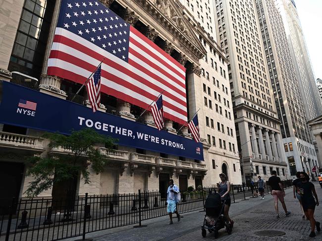 People walk outside the New York Stock Exchange on Wall Street. Picture: AFP